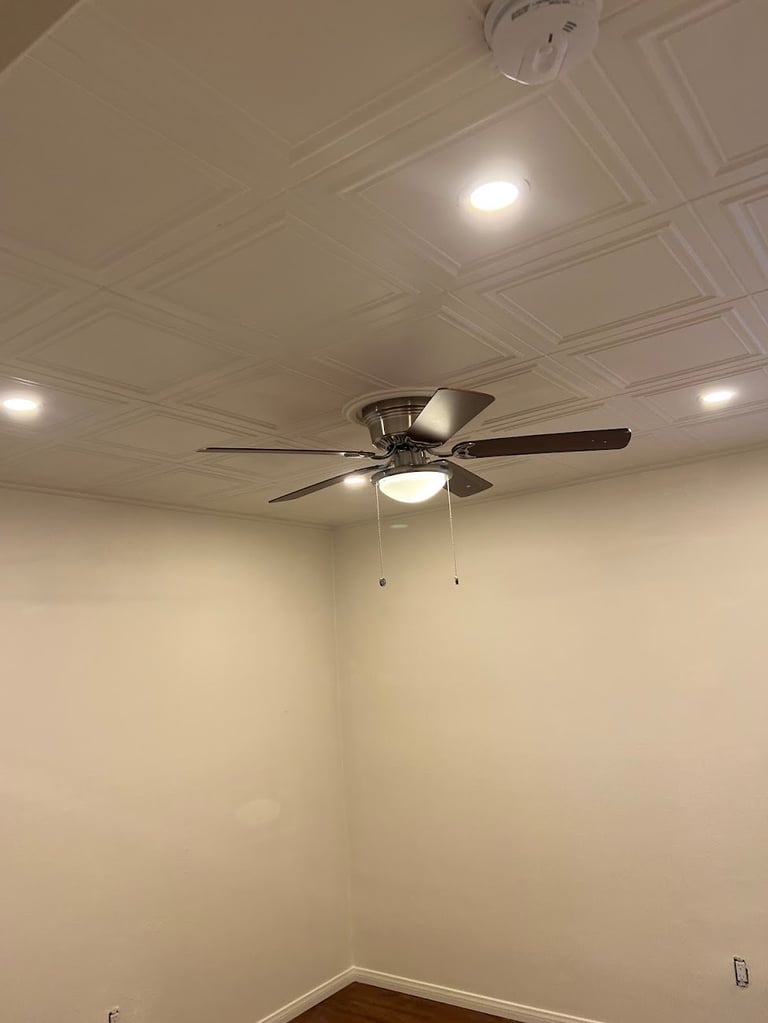 Modern ceiling fan with light fixture mounted on coffered ceiling
