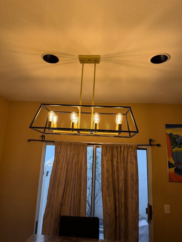 Modern rectangular pendant light fixture with four Edison-style bulbs above glass doors
