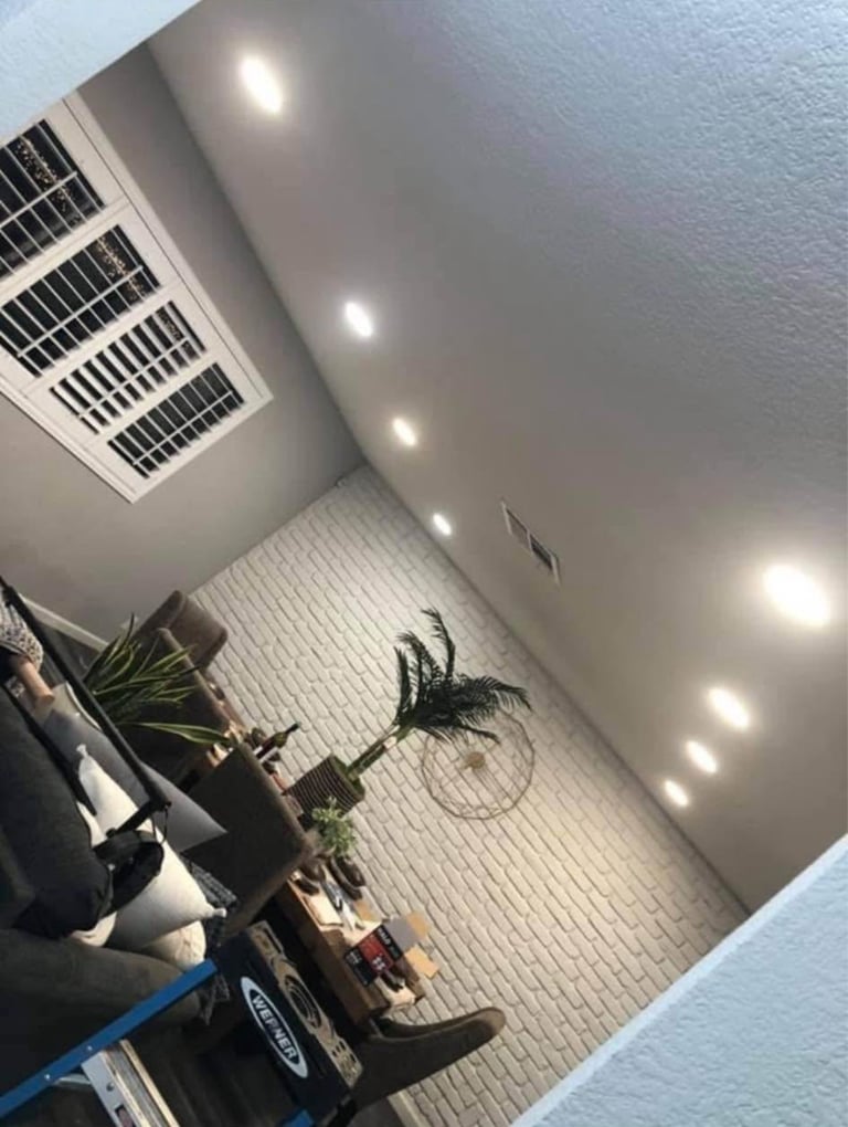 Modern white garage interior with recessed ceiling lights and HVAC vent