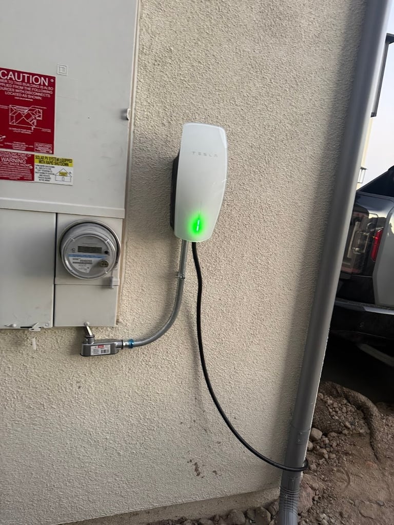 White electric vehicle charging station mounted on beige wall with green LED indicator light and black charging cable