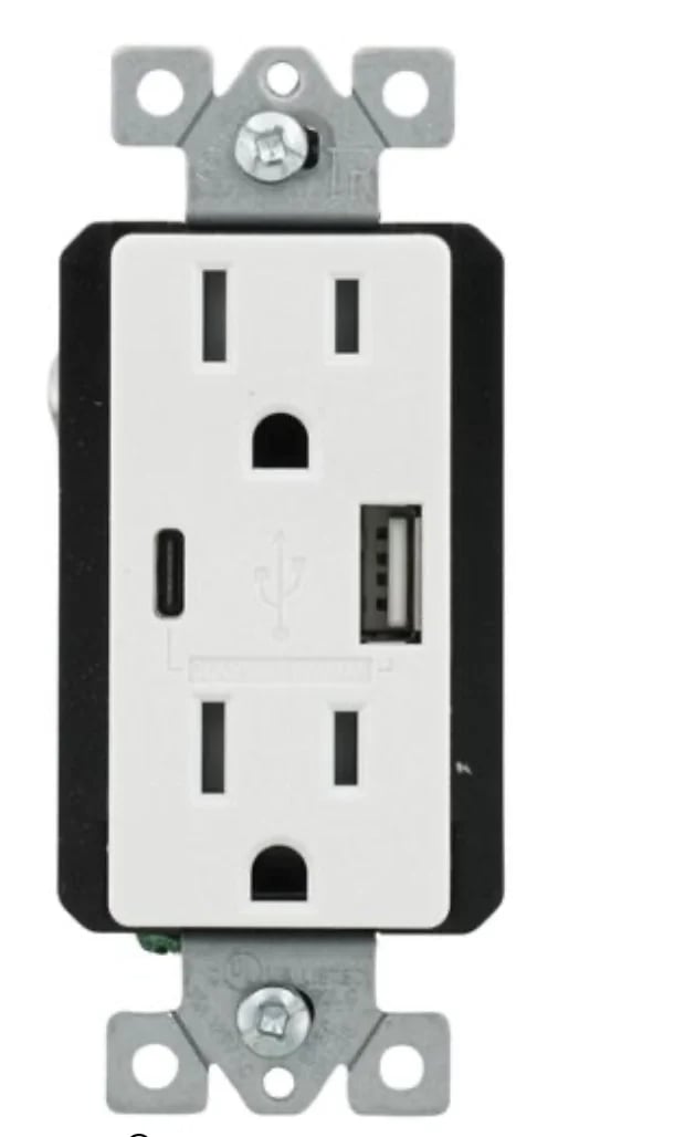 Man installing electrical wall switch and connecting wires inside white wall using screwdriver