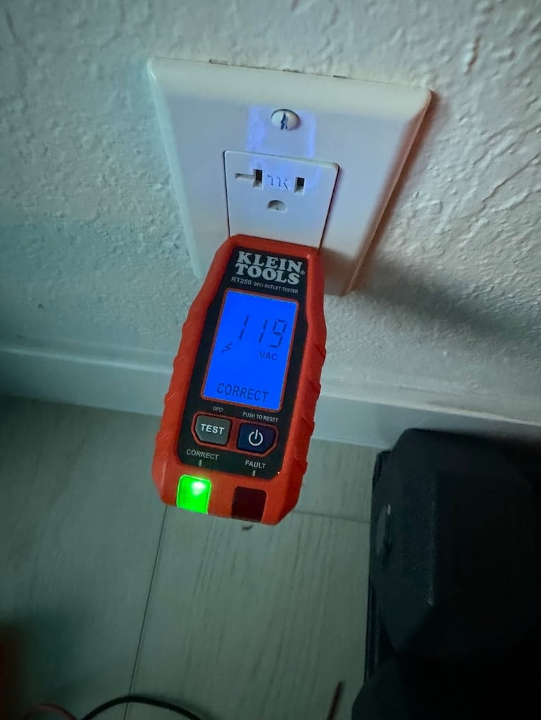 Klein Tools outlet tester with blue digital display and green indicator light plugged into wall outlet